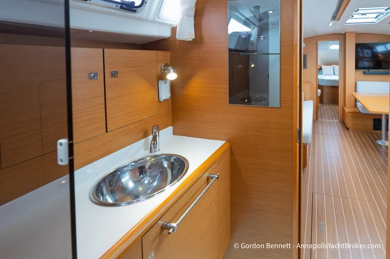 Slide: The Image of Interior of 2015 Jeanneau Sun Odyssey 439 yacht, featuring modern wood cabinetry and sleek design. - 53
