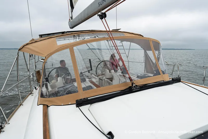 Slide: The Image of 2015 Jeanneau Sun Odyssey 439 sailing on calm waters with two people at the helm. - 20