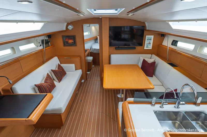 Slide: The Image of Interior of 2015 Jeanneau Sun Odyssey 439 yacht with modern furnishings and wood accents. - 4