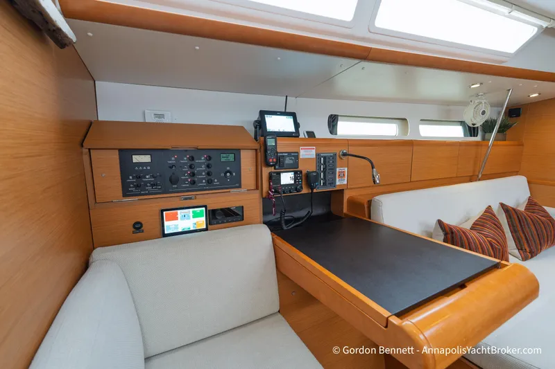 Slide: The Image of Interior of 2015 Jeanneau Sun Odyssey 439 yacht with navigation station and seating area. - 56