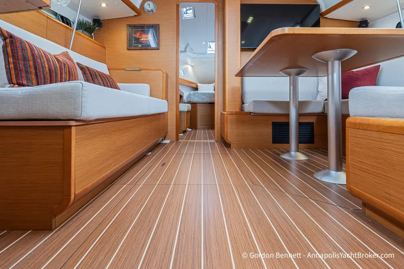 Slide: The Image of Interior of 2015 Jeanneau Sun Odyssey 439 yacht, featuring elegant wood finish and cozy seating. - 45