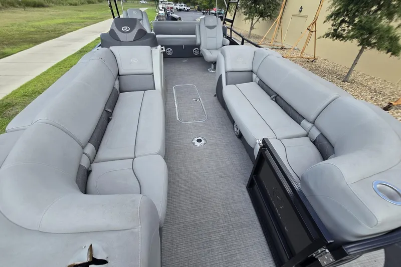 Slide: The Image of 2019 Regency 230 LE3 Sport pontoon boat with spacious gray seating and modern design. - 5