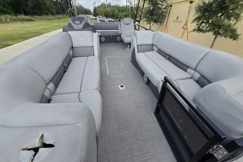 Slide: The Image of 2019 Regency 230 LE3 Sport pontoon boat interior with gray seating and spacious layout. - 8