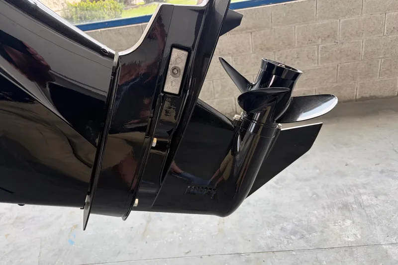 Slide: The Image of Close-up of a 2024 Boston Whaler 130 Super Sport boat propeller in a garage. - 25