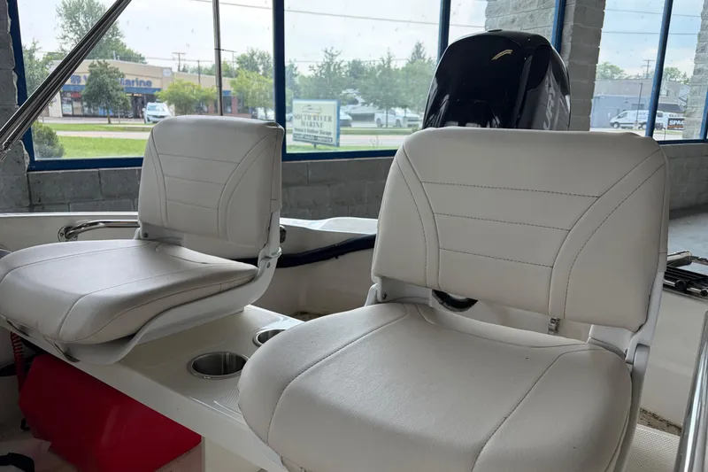 Slide: The Image of 2024 Boston Whaler 130 Super Sport boat interior with two white seats. - 21