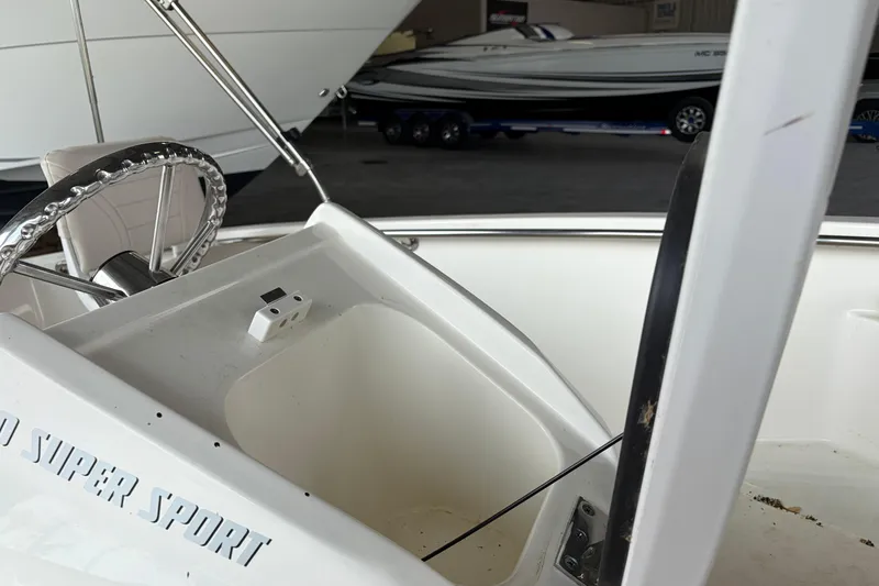 Slide: The Image of 2024 Boston Whaler 130 Super Sport boat interior with steering wheel and console. - 27