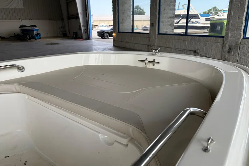 Slide: The Image of 2024 Boston Whaler 130 Super Sport interior view in a boat storage facility. - 17