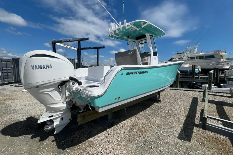 Slide: The Image of 2024 Sportsman Heritage 231 Center Console boat with Yamaha engine at marina. - 4