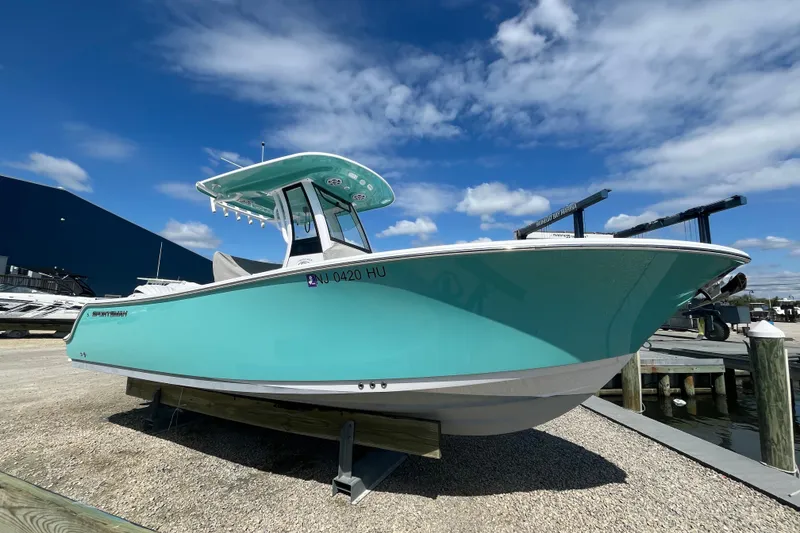 The Image of 2024 Sportsman Heritage 231 Center Console boat displayed outdoors under a blue sky. - 0