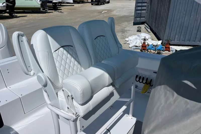 Slide: The Image of 2024 Sportsman Heritage 231 Center Console boat with white cushioned seating. - 6
