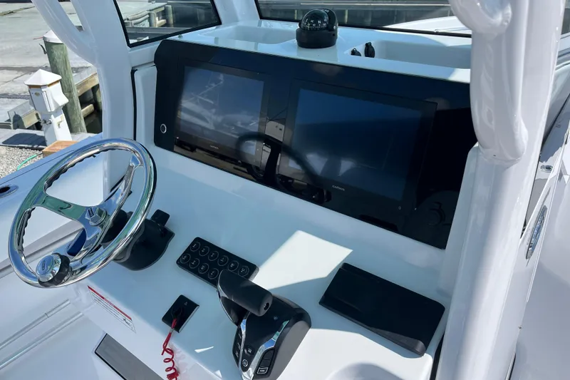 Slide: The Image of 2024 Sportsman Heritage 231 Center Console dashboard with steering wheel and navigation screens. - 10