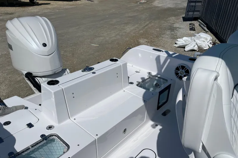 Slide: The Image of 2024 Sportsman Heritage 231 Center Console boat interior with engine and seating. - 13