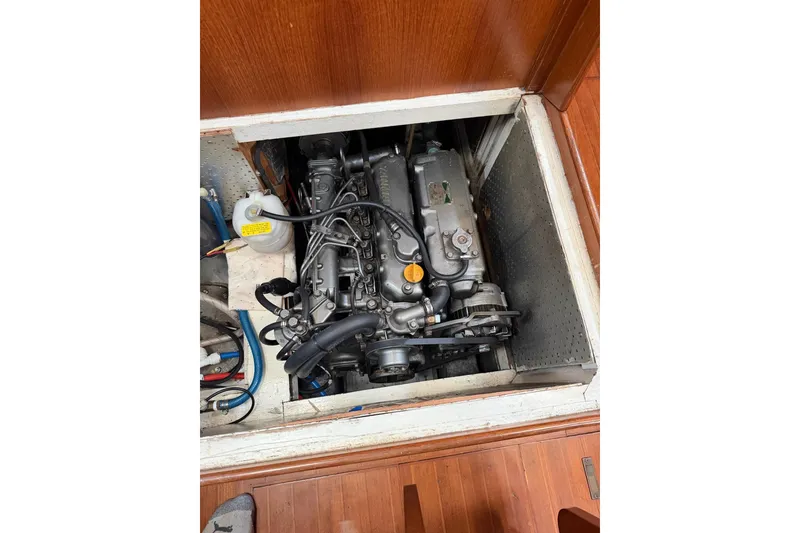 Slide: The Image of Engine compartment of a 1989 Tayana Vancouver 42 sailboat, showcasing mechanical components. - 30