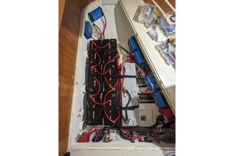 Slide: The Image of Electrical system setup in a 1989 Tayana Vancouver 42 sailboat, featuring batteries and wiring. - 31
