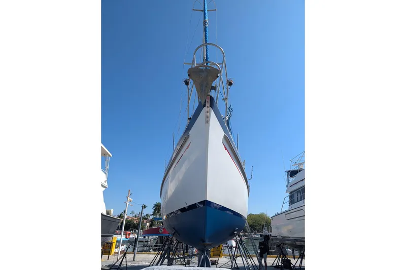 Slide: The Image of 1989 Tayana Vancouver 42 sailboat on stands under clear blue sky. - 16