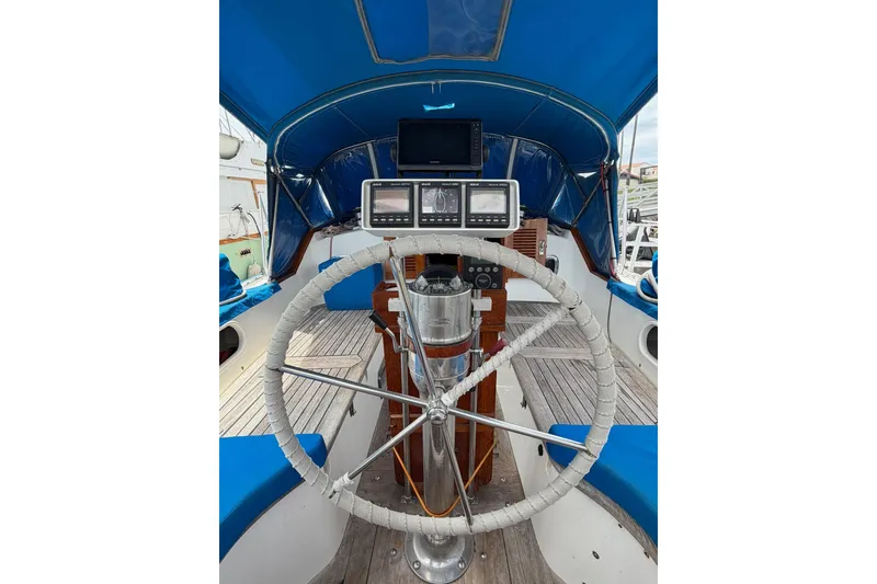 Slide: The Image of Cockpit of 1989 Tayana Vancouver 42 sailboat with steering wheel and navigation instruments. - 18