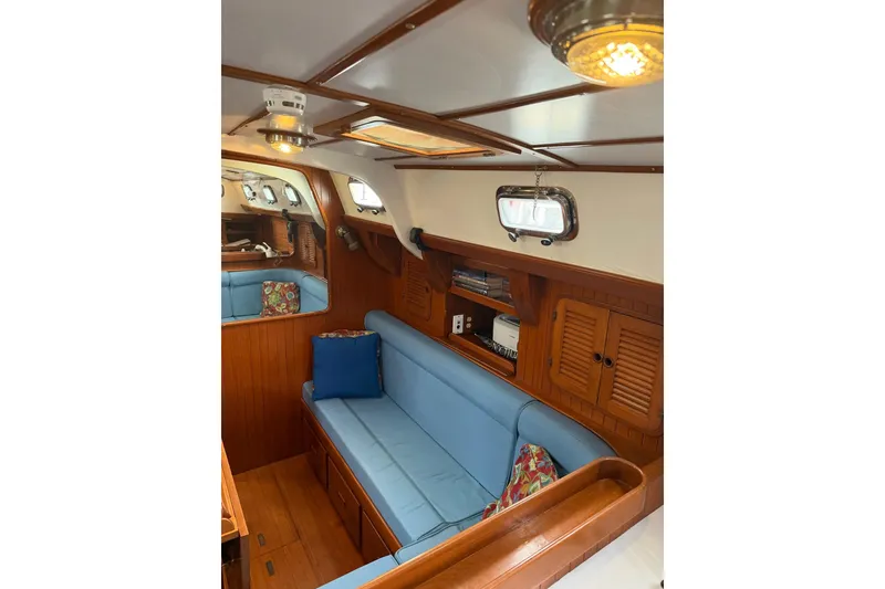 Slide: The Image of Interior of 1989 Tayana Vancouver 42 yacht with blue seating and wooden cabinetry. - 23