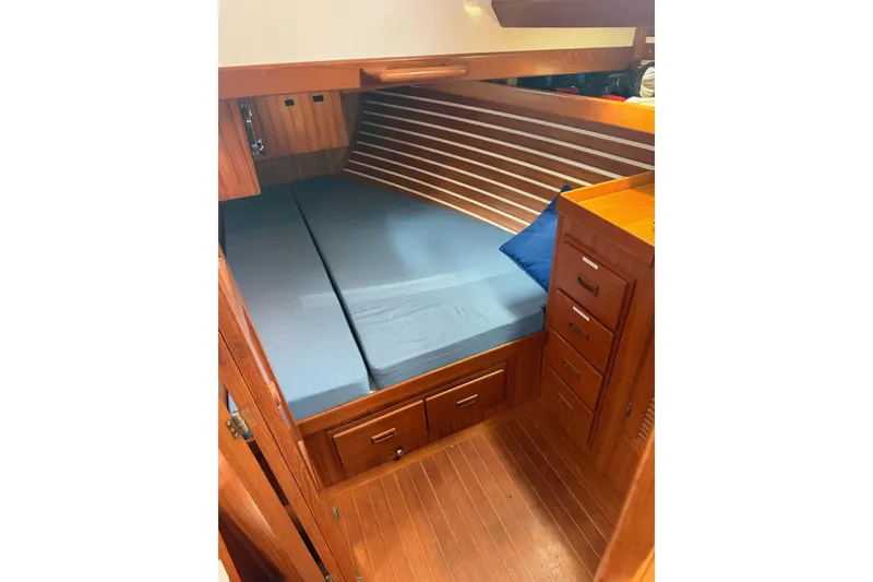 Slide: The Image of Cozy cabin interior of 1989 Tayana Vancouver 42 sailboat with wooden finish and blue bedding. - 28