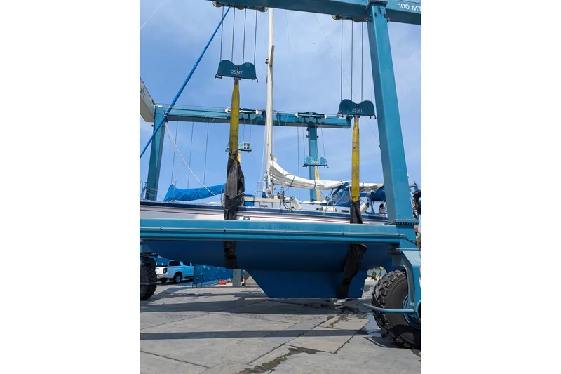 Slide: The Image of 1989 Tayana Vancouver 42 sailboat in dry dock, supported by a blue boat lift. - 33