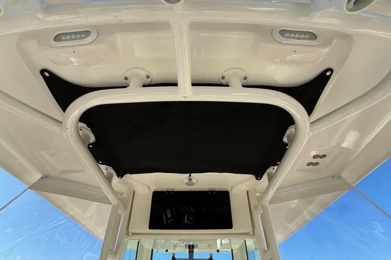 Slide: The Image of 2025 Boston Whaler 250 Outrage boat interior, featuring a sleek overhead design and modern fixtures. - 17
