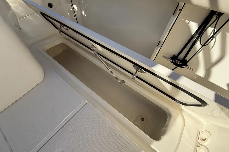 Slide: The Image of 2025 Boston Whaler 250 Outrage storage compartment, open and empty, showcasing interior space. - 26
