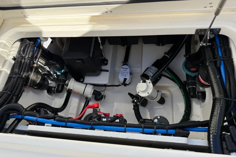 Slide: The Image of Engine compartment of 2025 Boston Whaler 250 Outrage, showcasing wiring and components. - 22