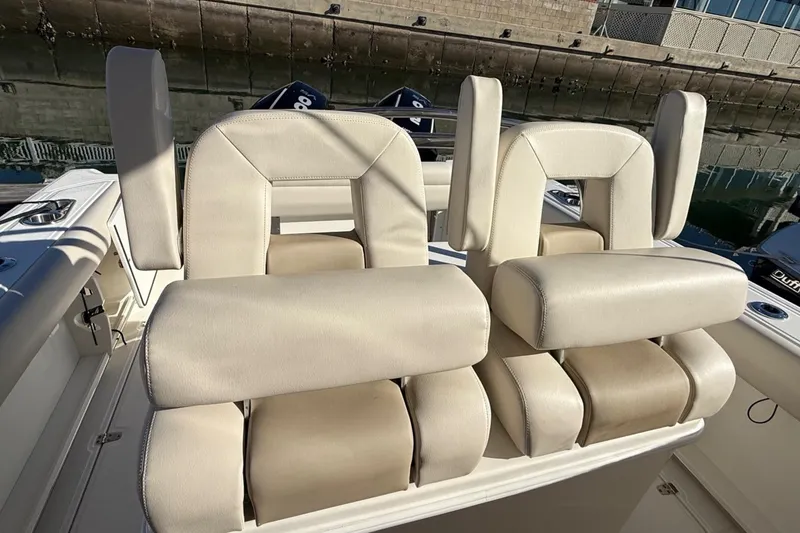 Slide: The Image of 2025 Boston Whaler 250 Outrage boat seats, featuring luxurious beige upholstery. - 32