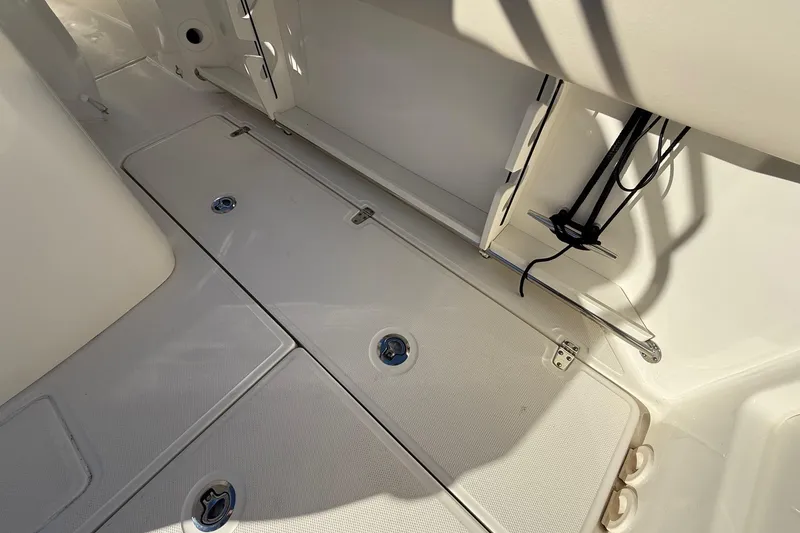 Slide: The Image of 2025 Boston Whaler 250 Outrage deck with storage compartments and clean design. - 25