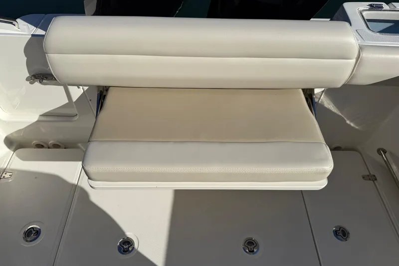 Slide: The Image of 2025 Boston Whaler 250 Outrage boat seat, beige upholstery, sleek design. - 21