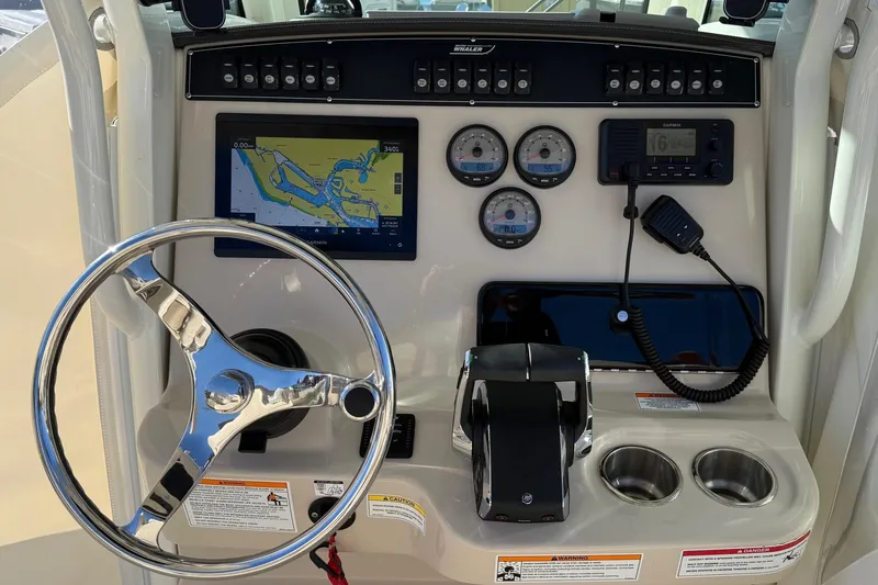 Slide: The Image of 2025 Boston Whaler 250 Outrage dashboard with navigation system and controls. - 29