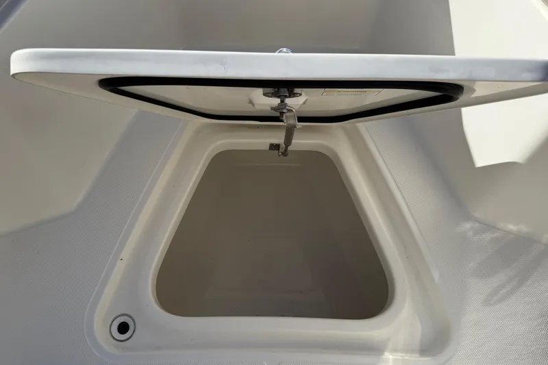 Slide: The Image of Open storage compartment on 2025 Boston Whaler 250 Outrage boat. - 43