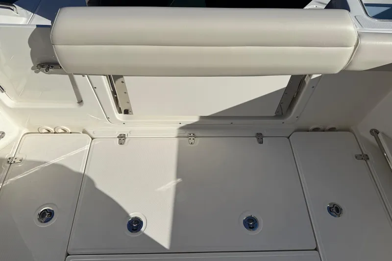 Slide: The Image of 2025 Boston Whaler 250 Outrage boat interior with cushioned seating and storage compartments. - 20