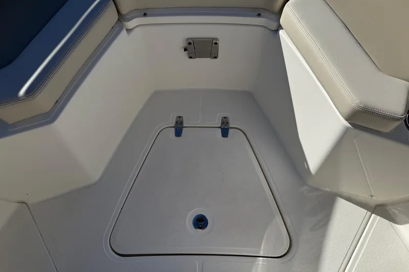 Slide: The Image of 2025 Boston Whaler 250 Outrage boat interior with storage compartment and cushioned seating. - 42