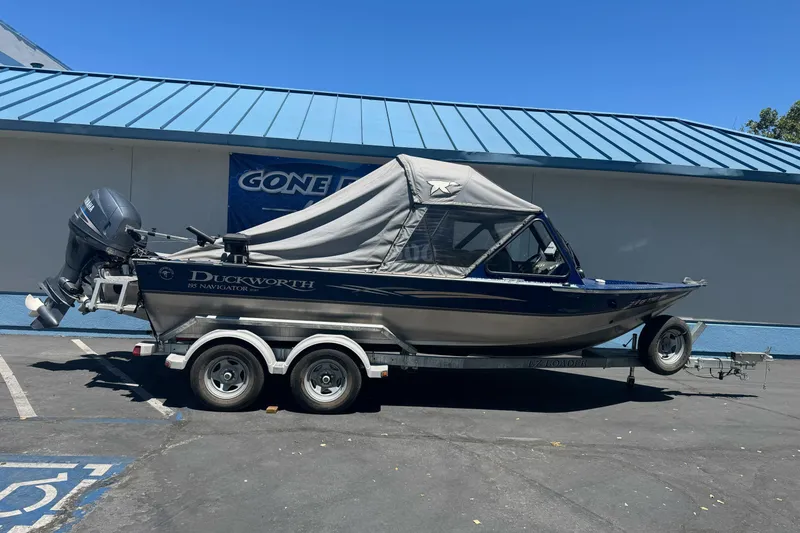 The Image of 2008 Duckworth Navigator Sport 195 boat on trailer, parked outdoors. - 1