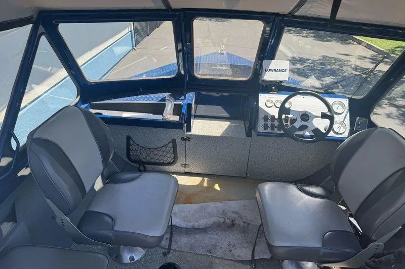 Slide: The Image of Interior of a 2008 Duckworth Navigator Sport 195 boat with steering wheel and seating. - 23