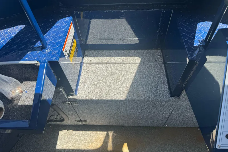 Slide: The Image of Interior of a 2008 Duckworth Navigator Sport 195 boat with blue and gray flooring. - 20