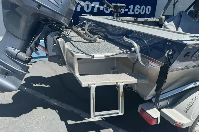 Slide: The Image of 2008 Duckworth Navigator Sport 195 boat with outboard motor and swim platform ladder. - 24