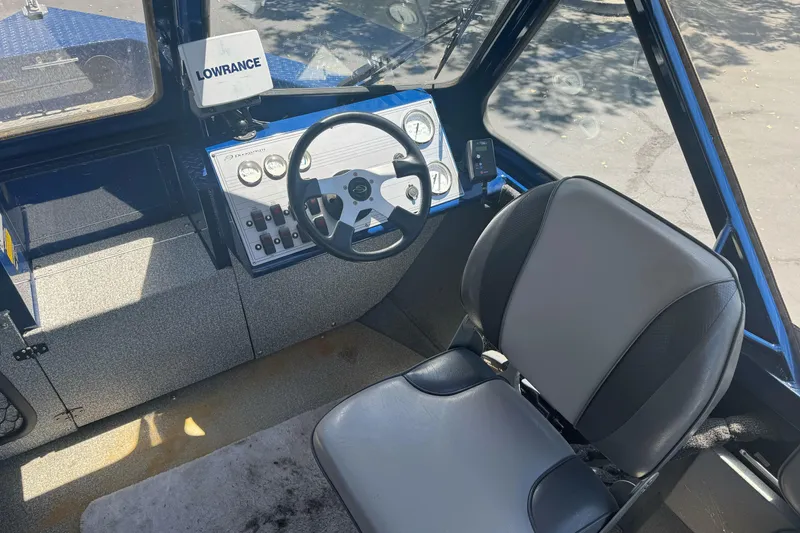 Slide: The Image of 2008 Duckworth Navigator Sport 195 boat interior with steering wheel and Lowrance equipment. - 16