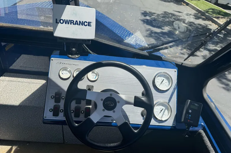 Slide: The Image of 2008 Duckworth Navigator Sport 195 dashboard with steering wheel and Lowrance navigation system. - 17