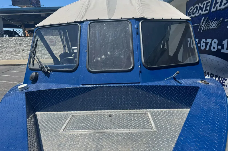 Slide: The Image of 2008 Duckworth Navigator Sport 195 boat with blue exterior and canopy, parked outdoors. - 6