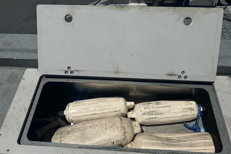 Slide: The Image of Open storage compartment on 2008 Duckworth Navigator Sport 195 boat with fenders inside. - 14