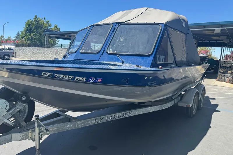 Slide: The Image of 2008 Duckworth Navigator Sport 195 boat on trailer, blue exterior, parked outdoors. - 5