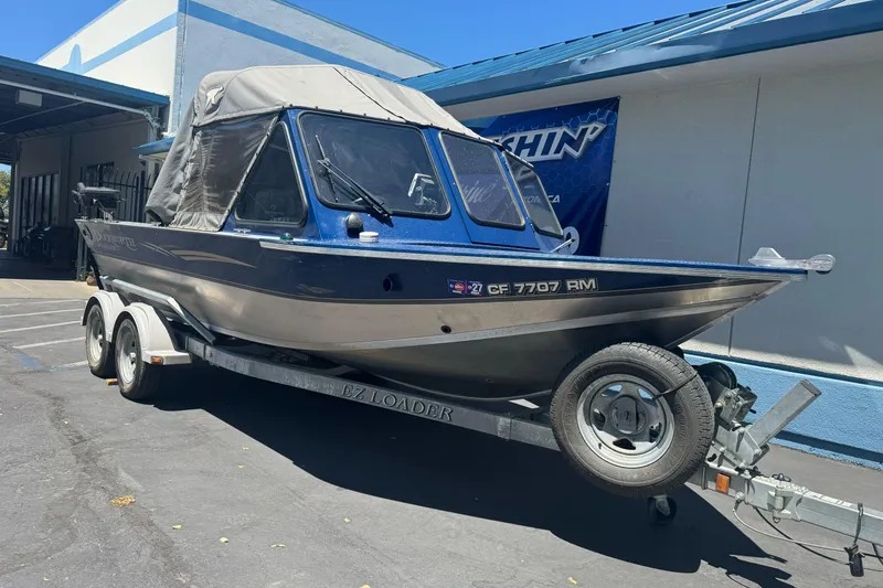 Slide: The Image of 2008 Duckworth Navigator Sport 195 boat on trailer, parked outside a building. - 9