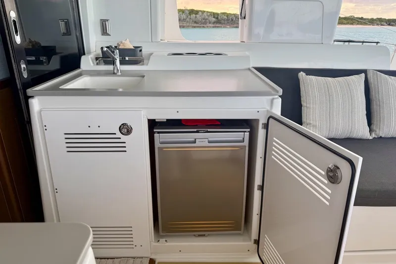 Slide: The Image of Modern kitchen area on a 2021 Lagoon 46 yacht with sink and mini fridge. - 35