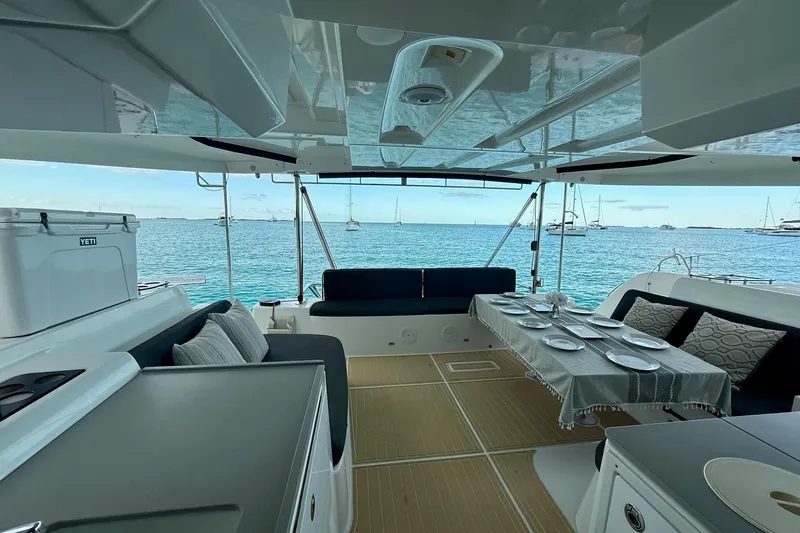 Slide: The Image of Luxurious 2021 Lagoon 46 catamaran interior with ocean view, featuring elegant dining setup. - 30