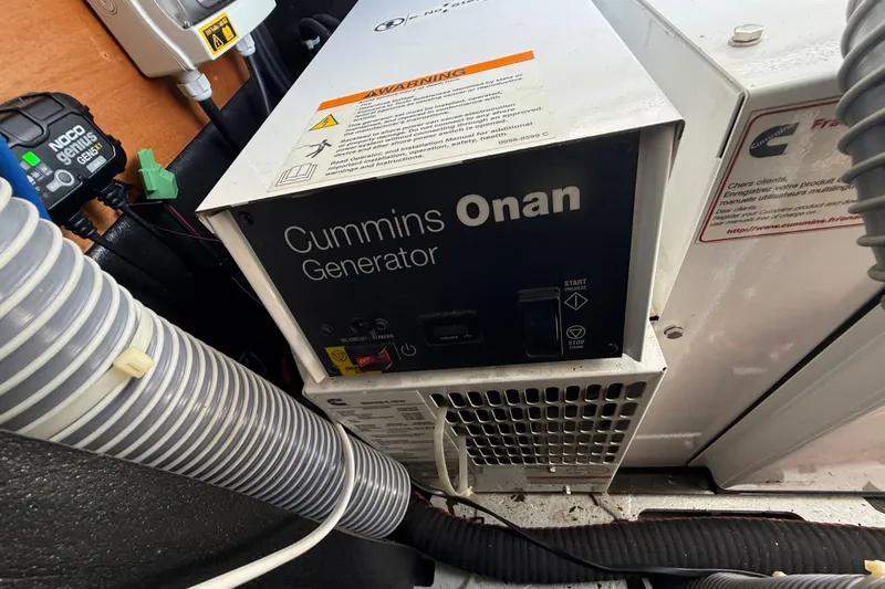 Slide: The Image of Cummins Onan generator inside a 2021 Lagoon 46 yacht engine room. - 97