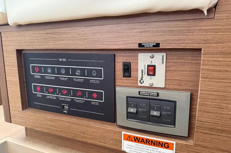 Slide: The Image of Control panel of a 2021 Lagoon 46 yacht with electrical switches and warning label. - 58