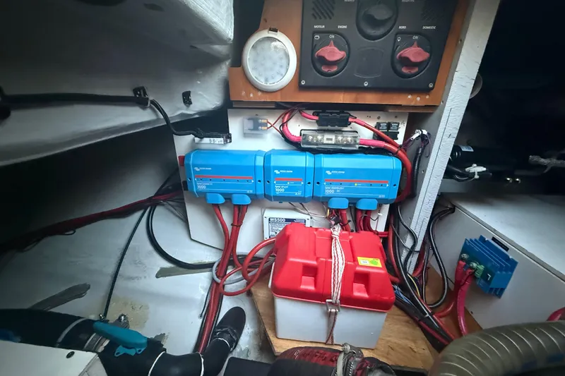 Slide: The Image of Electrical system setup in a 2021 Lagoon 46 yacht, featuring batteries and wiring. - 93