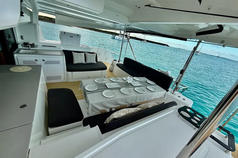 Slide: The Image of Luxurious 2021 Lagoon 46 yacht interior with elegant dining setup overlooking serene ocean waters. - 31