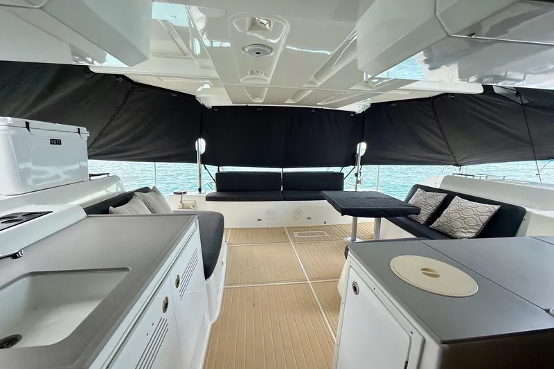 Slide: The Image of Luxurious interior of 2021 Lagoon 46 catamaran with modern seating and kitchenette. - 28